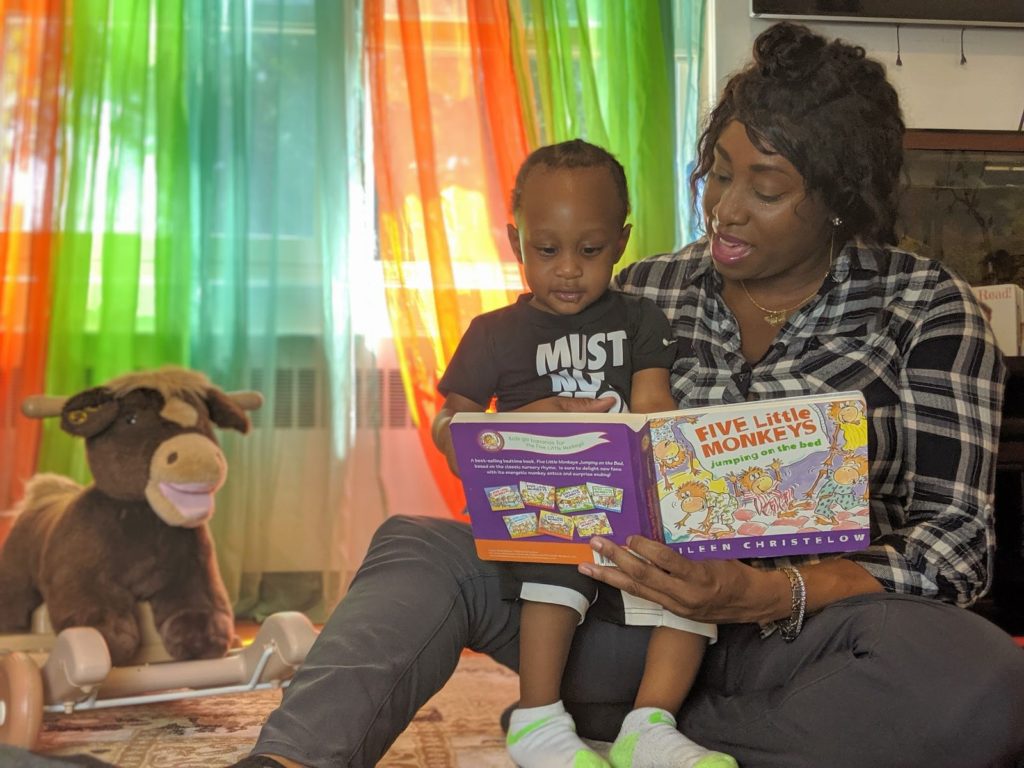 Letoya and her son read a book.